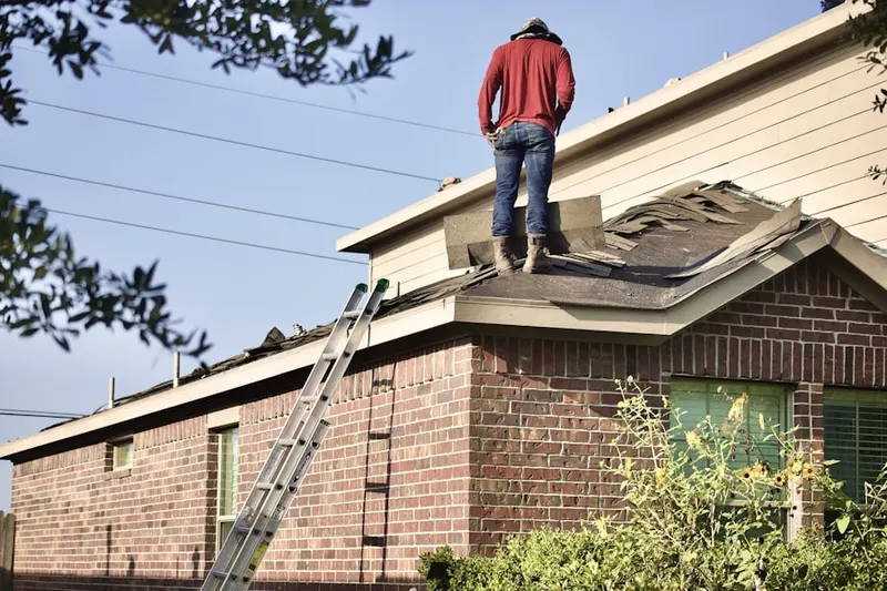 Professional roofer working on a residential roof in Pine Grove Park